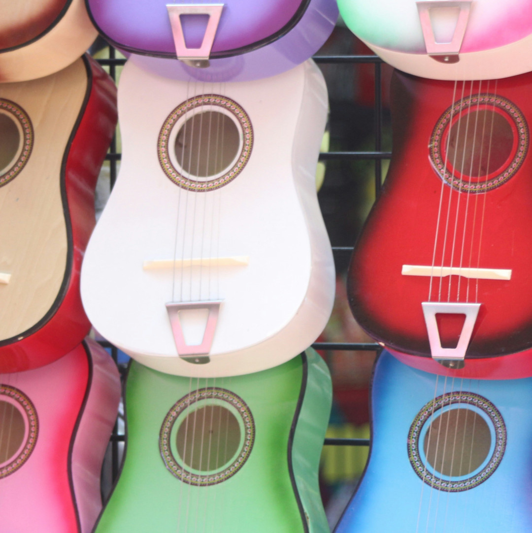 Colorful ukuleles hanging on the wall