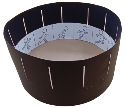 A zoetrope - a cylindrical animation tool - showing a running stick figure