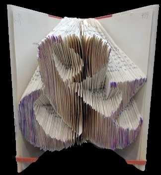 The folded edge of a book. The pages have been folded into the shape of an ampersand.