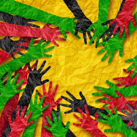 Image of black, red, and green hands reaching together to form a circle against a yellow background