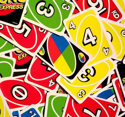 Colorful UNO cards in a chaotic pile