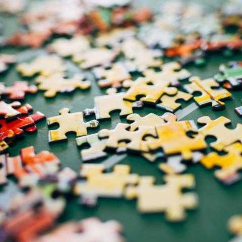 Pile of puzzle pieces on a green mat