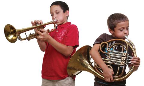 Two children playing horned instruments