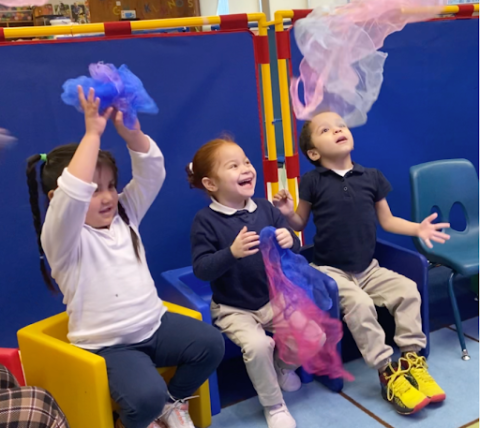 Photograph of children with diverse abilities experiencing musical instruments.