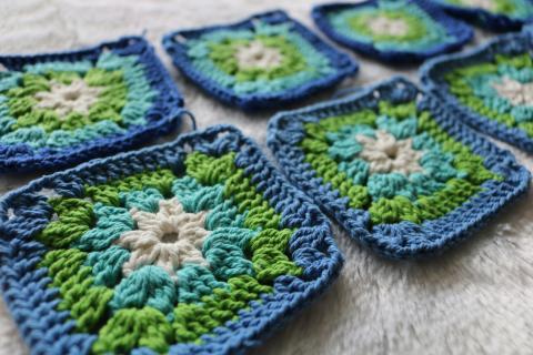 Crocheted granny squares in blue, green, and white