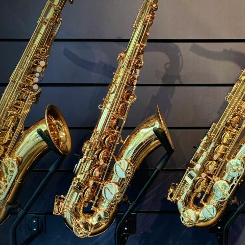 a row of saxophones mounted on a wall
