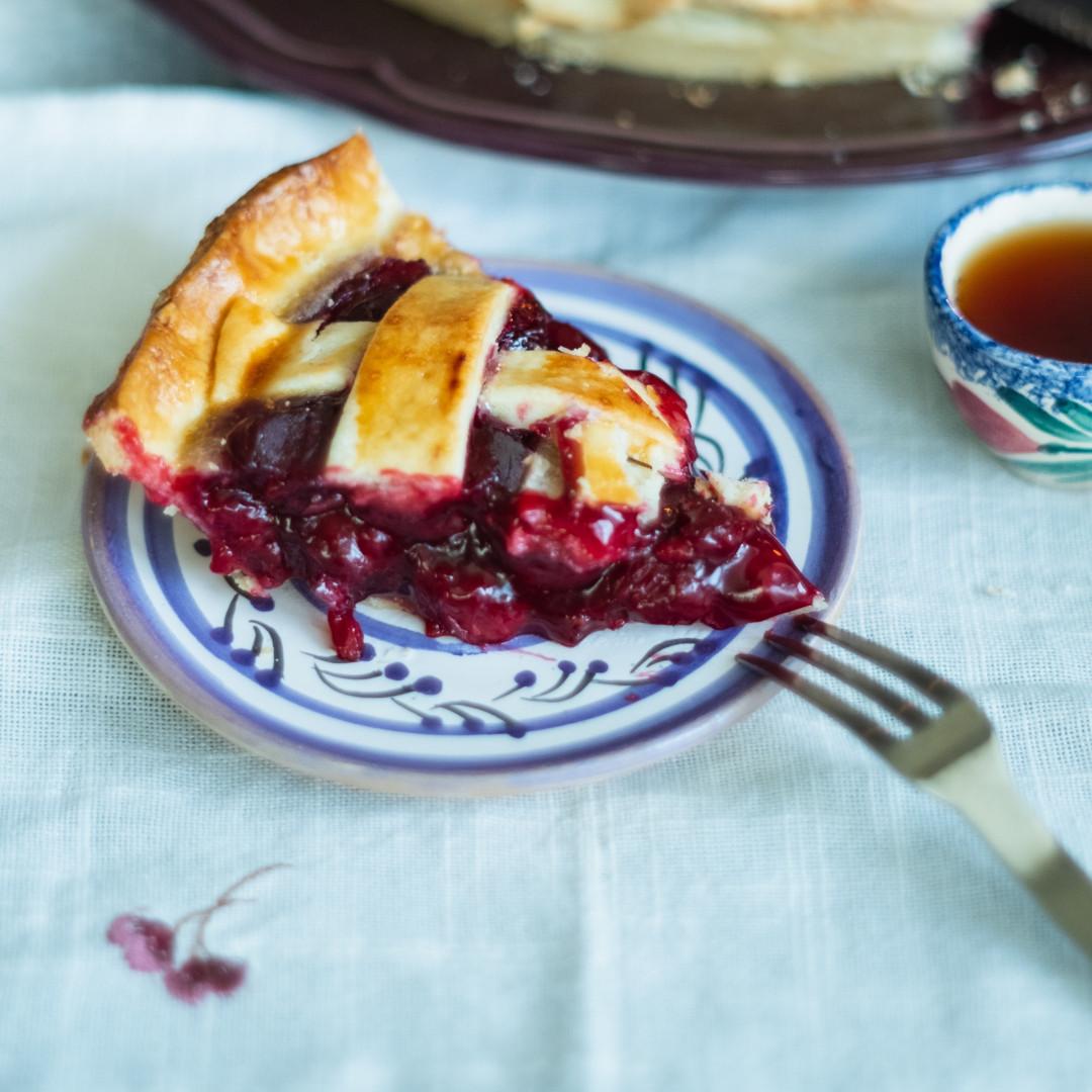 Slice of fruit pie on a blue and white plate