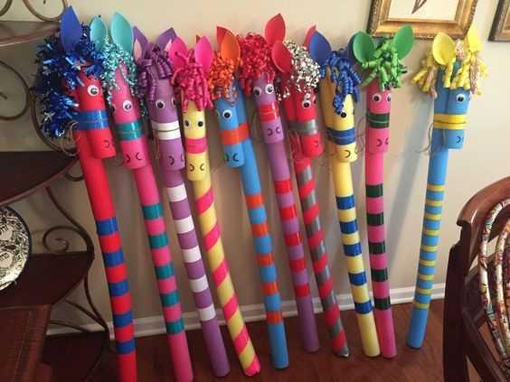 Stick horses made from pool noodles and colorful ribbons