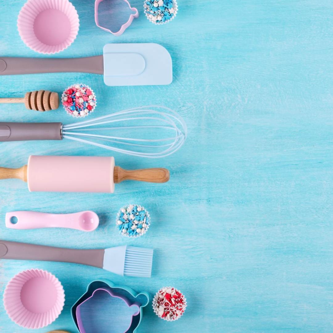 Pink baking supplies on an ice blue background